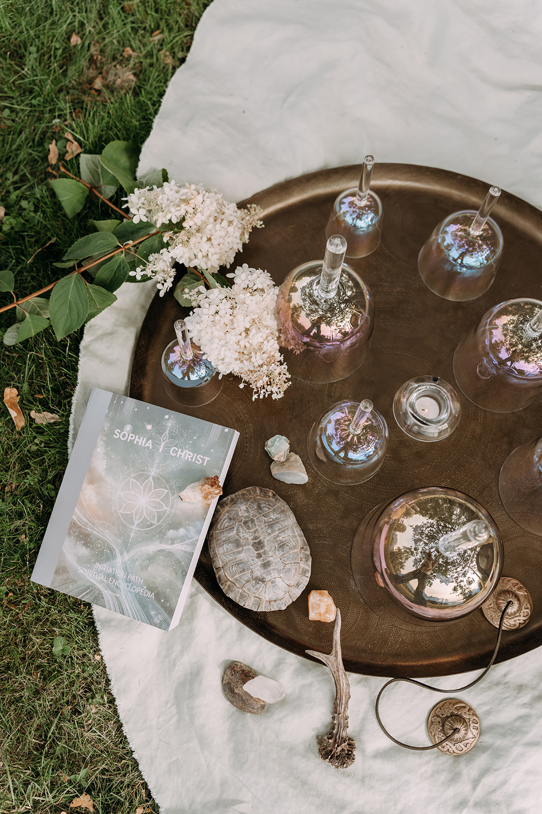 The Sophia Christ Initiation Path beside flowers and crystal bowls