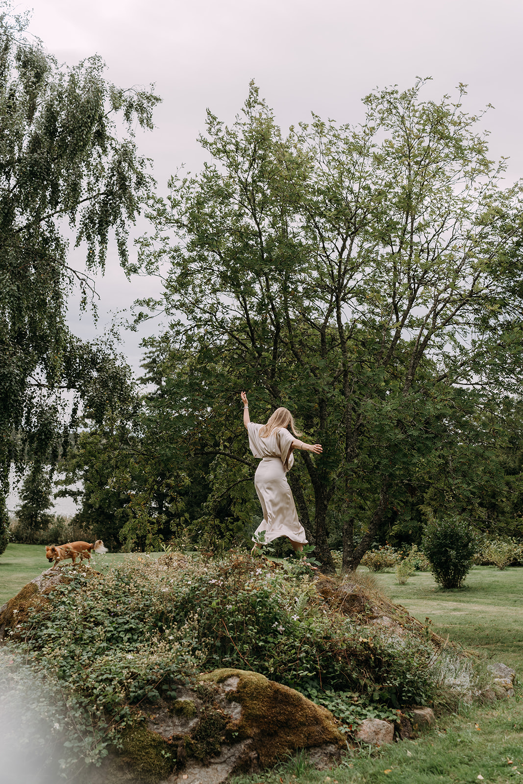 Päivi moving freely in a garden landscape